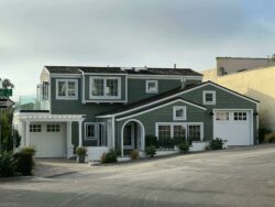 Modern green home siding and crisp white fascia