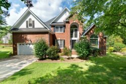 brick home with white soffit and fascia